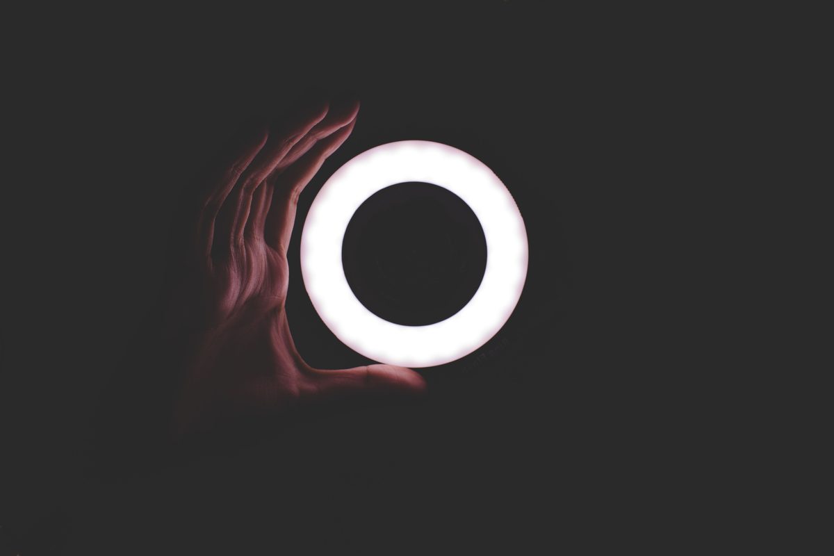 Hand holding a ring of light